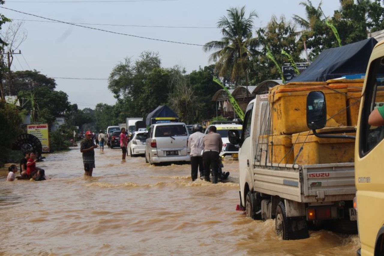 Pantau Banjir di Jalur Nasional, Polisi Trenggalek Bantu Dorong Motor hingga Bagikan Nasbung Kepada Warga Terdampak
